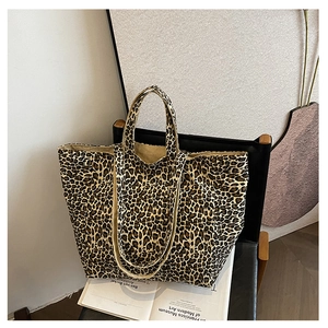 Macro shot of stylish leopard print canvas tote bag with thick texture on a modern chair