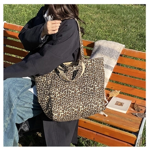 Outdoor lifestyle view of large leopard print canvas tote bag with shoulder strap
