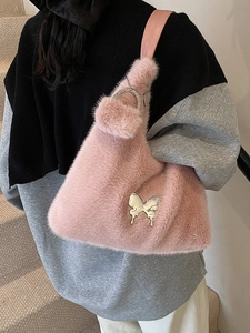 Pink plush faux fur shoulder bag with silver butterfly charm and chain handle
