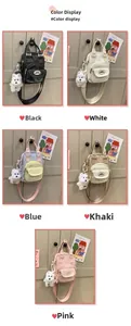 Detail view of mini canvas crossbody bags in five candy colors with puppy charms