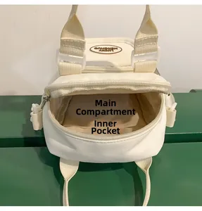 Detail view showing internal structure of small white canvas bag with zipper and inner pocket