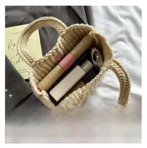 Interior view of beige knitted bucket bag showing capacity for phone and wallet