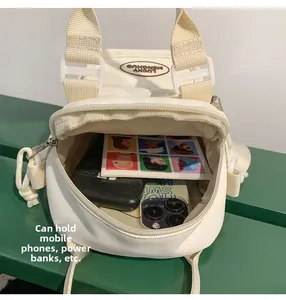 Detail view of cream canvas crossbody bag showing inner space for phone and power bank