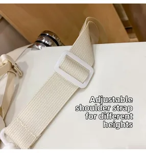 Detail view of adjustable cream woven strap with white plastic buckle for different heights