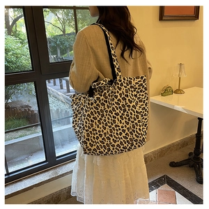 Detailed view of leopard print canvas tote bag with large capacity and black handles