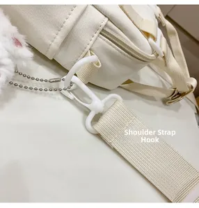 Detail of white plastic strap hook and canvas strap with fluffy charm accessory