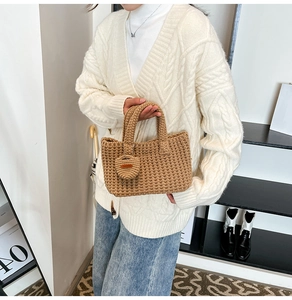 Close-up of brown knit texture on bucket bag with matching round charm accessory