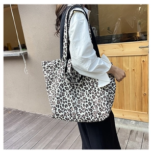 Detailed close-up of leopard print canvas tote bag showing texture and fabric durability