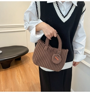 Close-up of knit bucket bag with brown texture and handmade charm detail