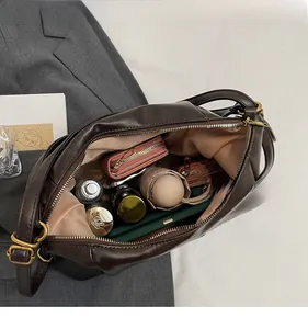 Macro view of interior storage space of the dark brown leather tote with metal ring