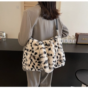 Detailed view of the soft black and white spotted plush texture on the tote bag