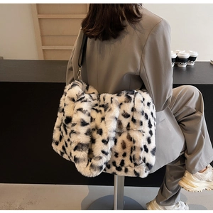Close-up of fluffy leopard print tote bag showing plush faux fur texture and gold hardware