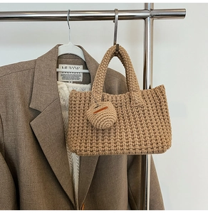 Detailed texture of khaki knit handbag with a matching mini round pendant on a hanger