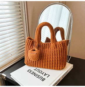 Detail of hand-knitted caramel orange tote bag with crochet texture and handmade tag