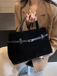 Minimalist black frosted tote bag with metal buckle detail and sturdy round handles