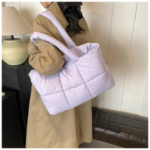 Close-up of lavender quilted puffer tote bag with wide padded shoulder straps for women