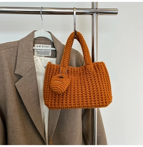 Detailed knit texture of caramel brown handmade bucket bag with matching mini coin pouch