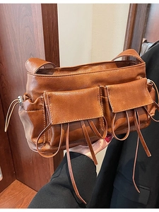 Vintage brown leather bowling bag with bow pleats and stylish fringe detail