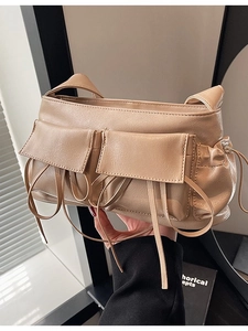 Chic beige bow-knot bowling shoulder bag with functional flap pockets and decorative ribbons