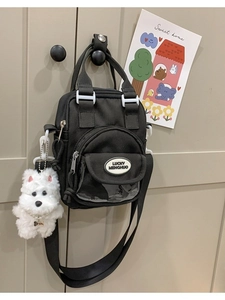 Black canvas mini crossbody bag with cute puppy pendant and pearl chain detail