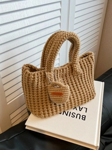 Fashionable waffle knit tote bag with thick handles and handmade charm detail
