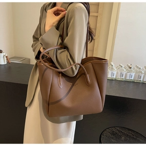 Brown litchi grain leather tote bag with Fashion Trend text shown in a stylish interior