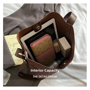 Detailed view showing the large internal capacity of the brown suede bucket bag