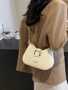 Chic cream-colored half-moon underarm bag with silver buckle and contrast stitching details