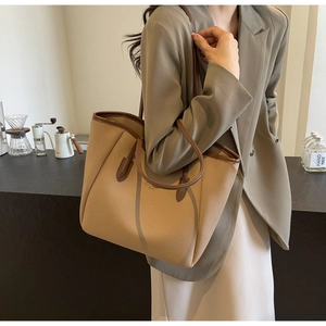 Brown litchi grain tote bag with large capacity shown in a daily lifestyle scene