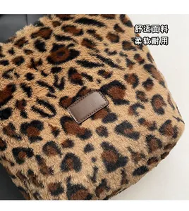 Detailed view of plush leopard print fabric with premium brown leather logo patch