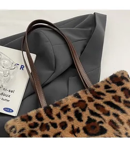 Close-up of leopard print plush tote bag with premium leather shoulder strap detail