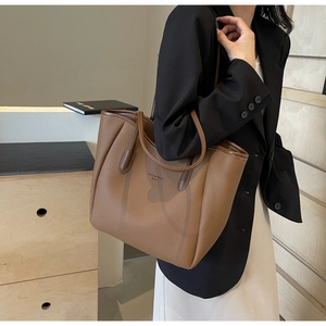 Detail of caramel brown tote bag in pebbled faux leather with stylish fashion trend print