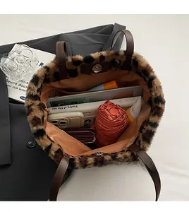 Spacious interior of leopard print tote bag holding umbrella, phone, and daily essentials