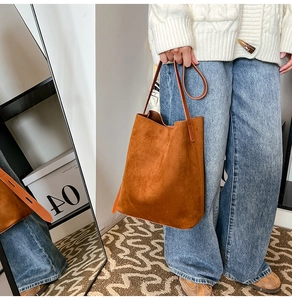 Detail of caramel suede tote bag featuring a spacious interior and minimalist shoulder strap