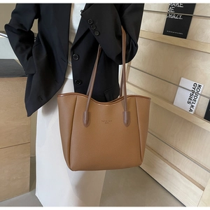Caramel lychee grain tote bag shown in a fashion lifestyle setting with a stylish outfit