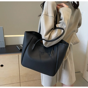 Detail of black tote bag with litchi texture and Fashion Trend Selected text