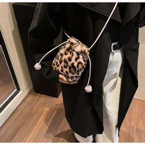 Detail of leopard print faux fur bucket bag with pink drawstring and soft texture