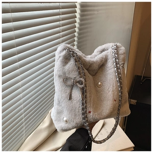 Détail du sac seau en fausse fourrure gris clair avec perles et nœud en strass
