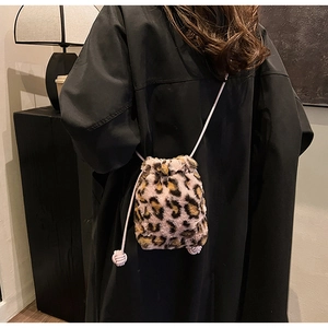 Close-up of leopard print plush bucket bag featuring purple woven drawstring and soft texture