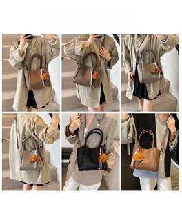 Detail view of retro PU bucket bags in brown, grey, and black with plush puppy charm
