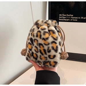Detail of soft leopard print faux fur bucket bag with brown drawstring and knot detail