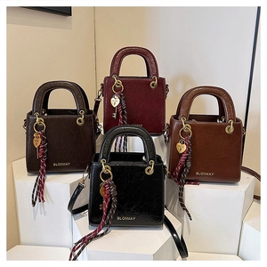 Detail of four retro small square handbags with heart lock charms and silk scarves
