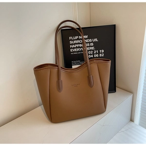 Close-up of caramel brown pebble leather tote bag with Fashion Trend logo text