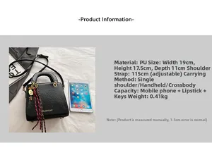 Close-up of black litchi pattern PU leather handbag with woven tassel and metal key charm