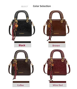 Detail view of four retro square bags in black, brown, coffee and wine red colors