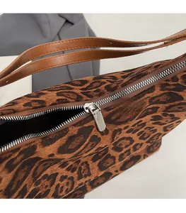 Close-up of leopard print tote featuring high-quality silver zipper and smooth texture