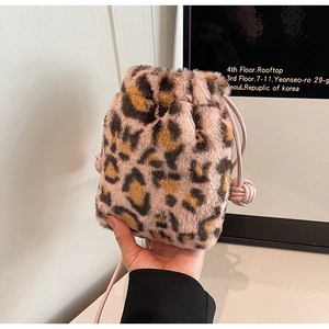 Detail of leopard print plush bucket bag with pink fur and leather drawstring knot
