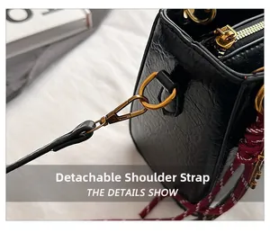 Detail of high-quality black faux leather bag with gold hardware and detachable strap