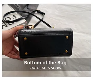 Detail view of the black oil wax leather bag bottom with golden protective metal feet