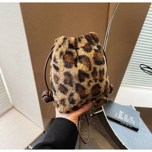 Detail of leopard print faux fur bucket bag featuring drawstring closure and soft texture
